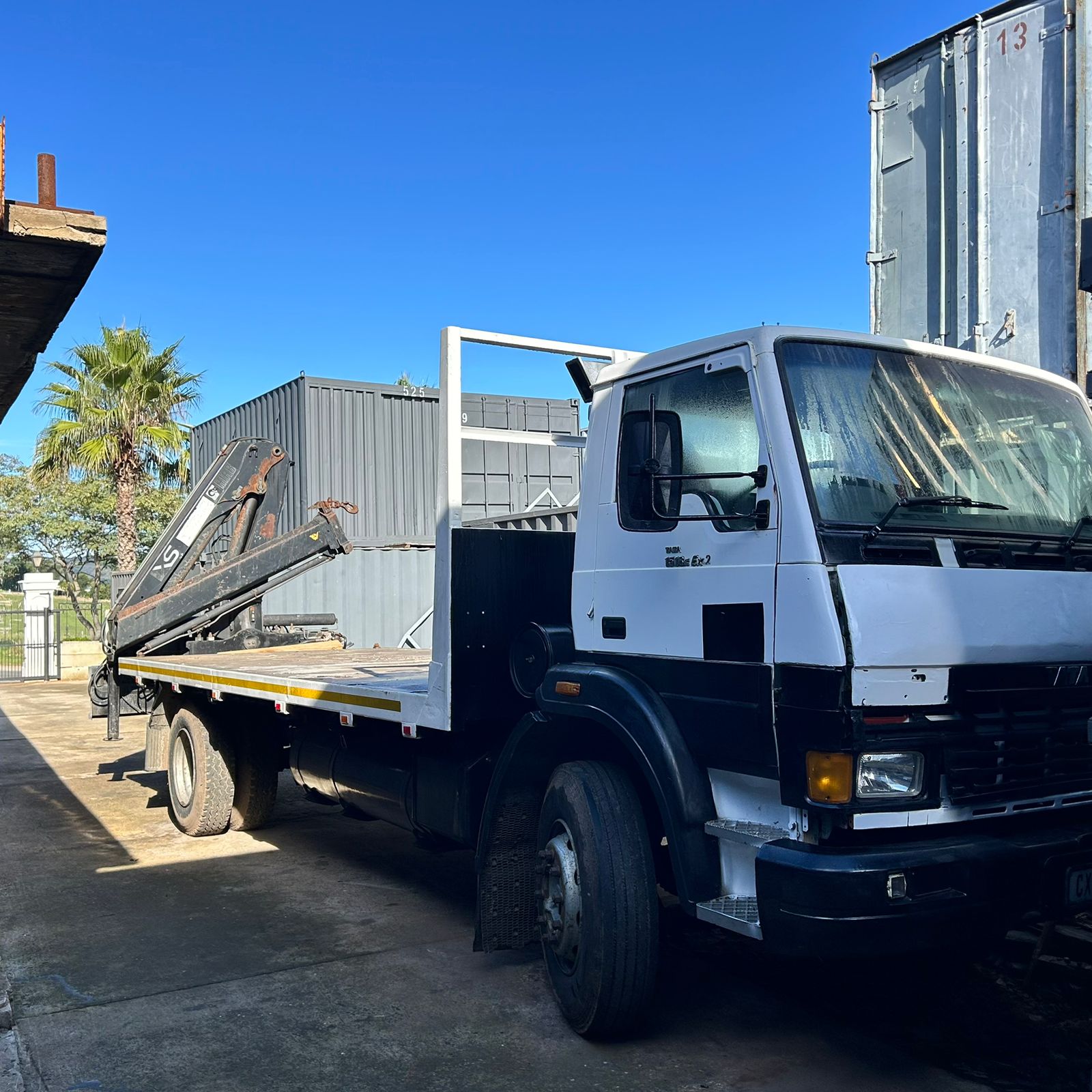 Strode Containers truck and crane positioning a shipping container for a client